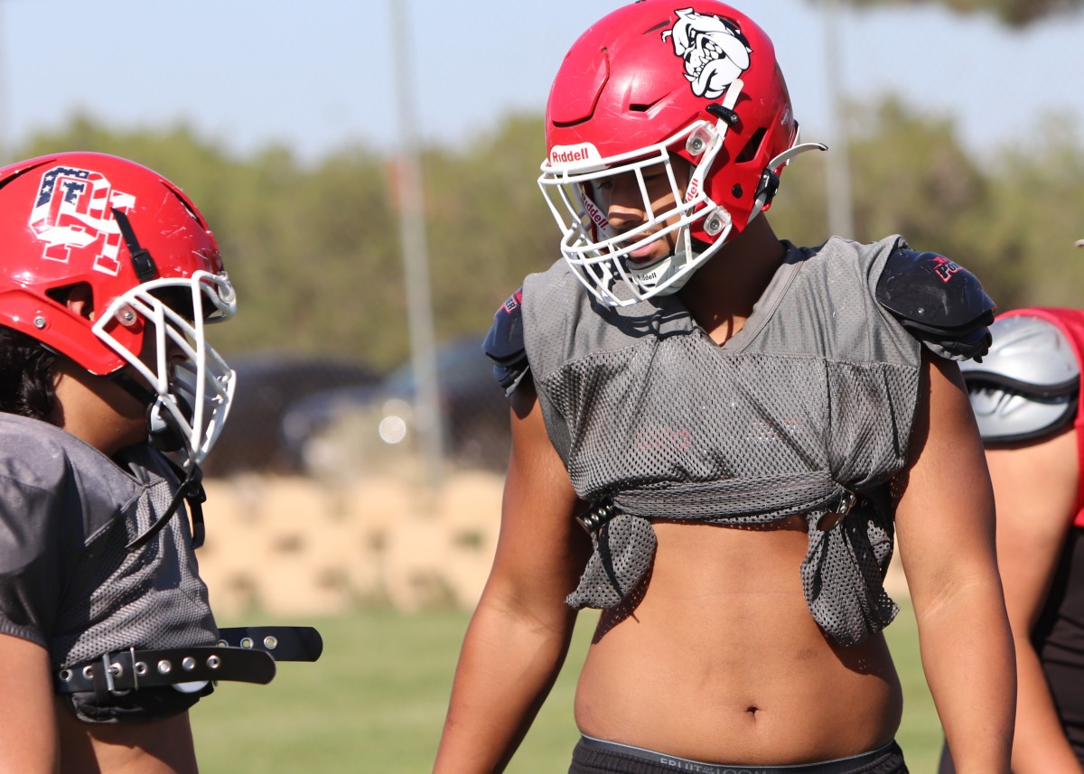 Teammates literally and figuratively look up to 6-foot-5, 260-pound Paki Fanau (right). Photo: John Murphy
